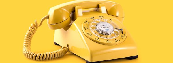 Yellow telephone on yellow background