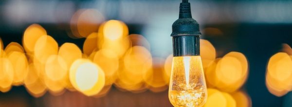 Warm temperature lightbulb in focus, with many out of focus in the background