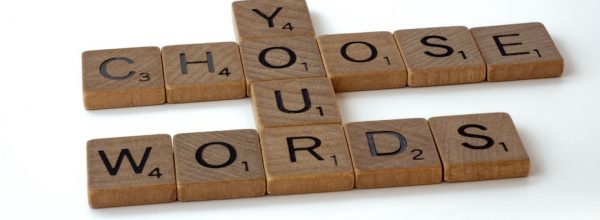Scrabble tiles that spell 'Choose your words'