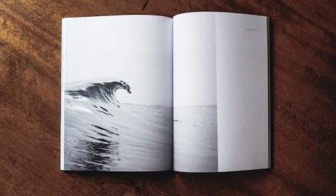 Open book with the image of a cresting wave